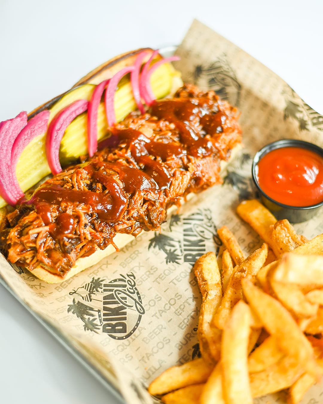 BBQ pulled meat sandwich with pickles and fries at Cabo Joe's